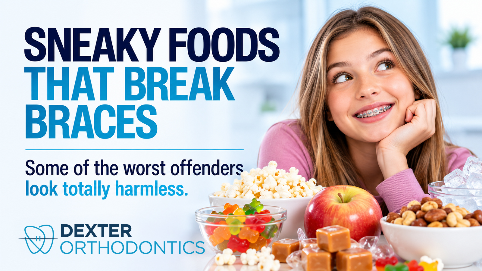 A smiling teen with metal braces rests her chin on her hand behind bowls of popcorn, gummy bears, caramels, nuts, ice, and an apple, foods that can damage braces.