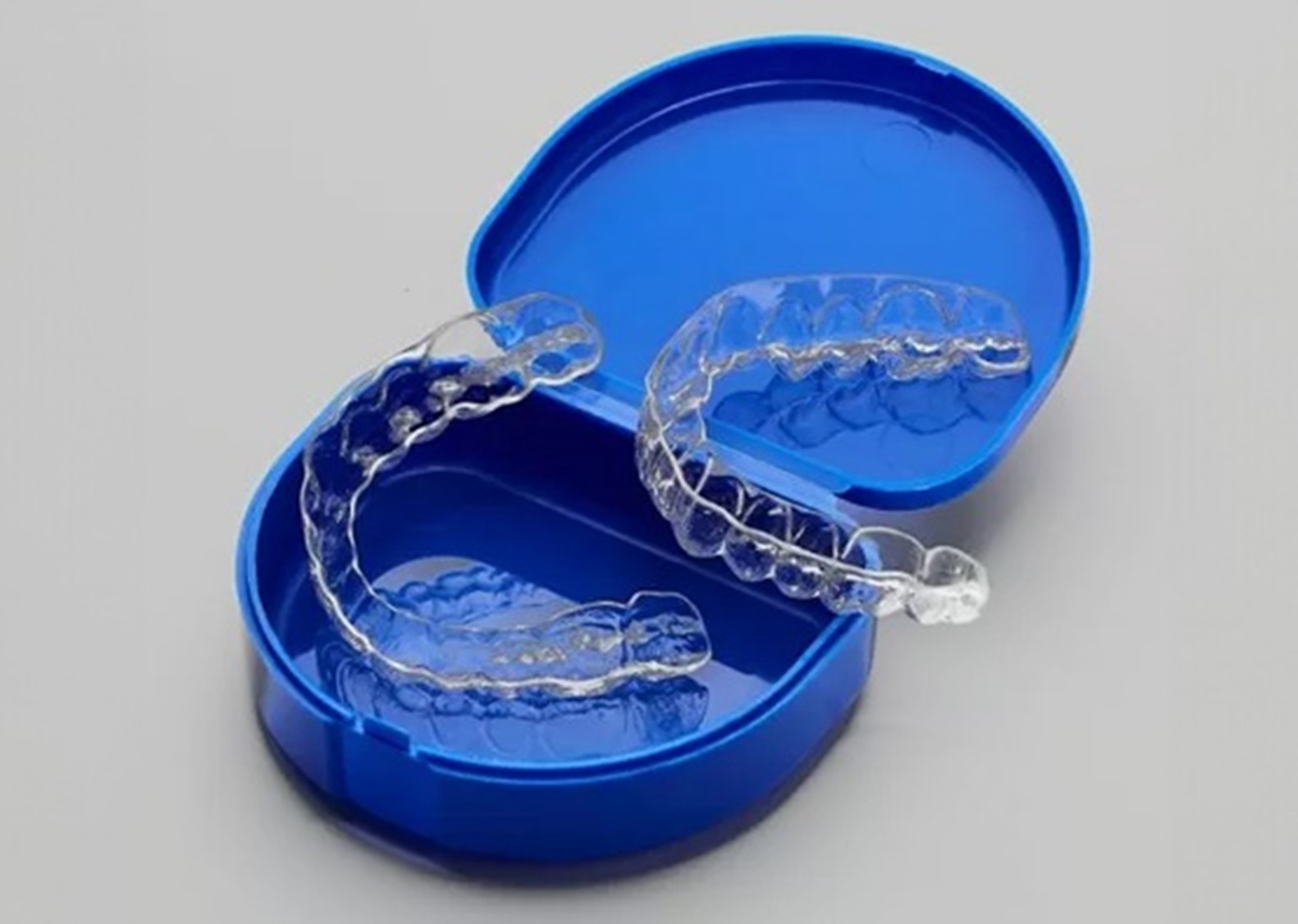 a clear retainer in a blue case